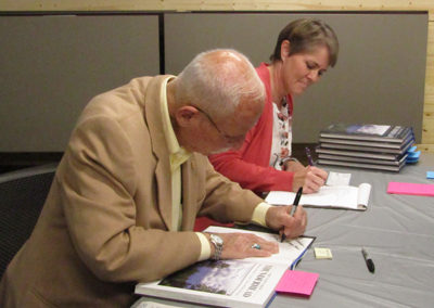 Ray Hunkins autographs a copy of The View from Thunderhead